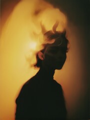 A silhouette of a woman with her hair blowing in the wind.