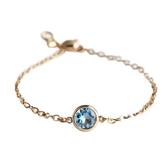 Fototapeta premium Gold chain bracelet blue gemstone isolated on a white background.