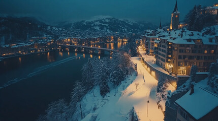 Obraz premium Snow-covered town lights up at dusk along a peaceful river