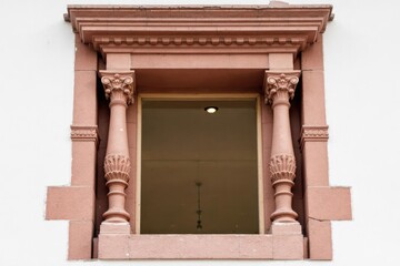Architectural detail of old building with columns in window frame