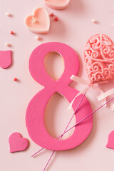 Fototapeta premium Number eight with hearts on a pink background. International Women's Day concept