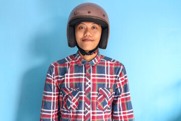 Handsome Asian man wearing motorbike brown helmet