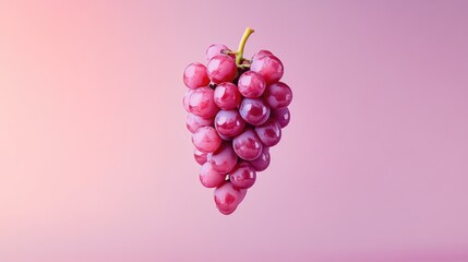 A minimalist shot of a single grape cluster suspended in the air against a soft gradient background.