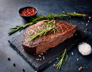 Grilled sliced Beef Steak with tomatoes and rosemary on a plate Isolated on white background top view