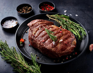 Grilled sliced Beef Steak with tomatoes and rosemary on a plate Isolated on white background top view
