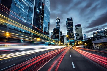 Fototapeta premium Vibrant cityscape showcasing glowing light trails along a busy road, tall illuminated skyscrapers against a cloudy sky, concept of urban energy. Ai generative