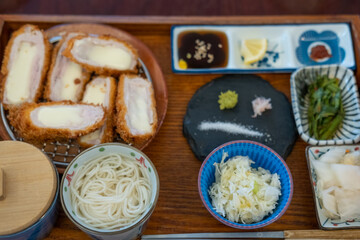 Cheese Tonkatsu, Fried Pork set with sauce, rice and soup serve on plate in restaurant