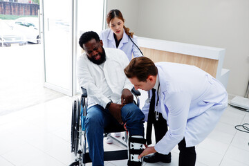 Doctors care for a patient with a broken leg in a wheelchair.