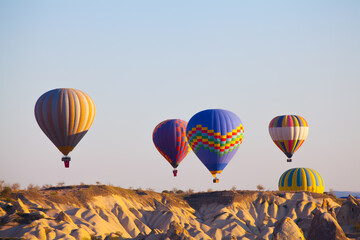 Obraz premium Hot air balloons rising with tourists. Tourist having fun and taking photos.