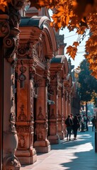 Ornate building facade in autumn. People stroll along the sidewalk, bathed in sunlight filtering through golden leaves.