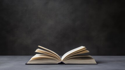 An open book resting on a dark surface, showcasing its pages and inviting readers to explore its...