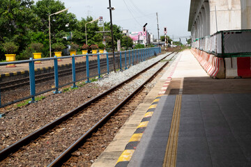Naklejka premium Cityscape of railroad track or rail way at upcountry train station with platform and construction of Thailand High-speed Rail Project 