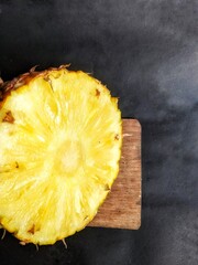 Pineapple fruit slices on black background
