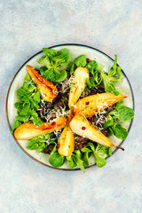 Salad with liver, caramelized pear in a plate.