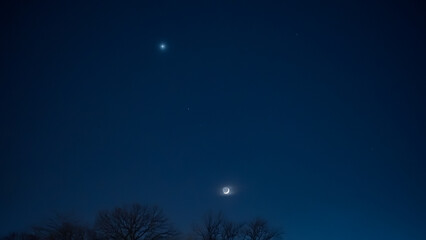 Crescent young Moon with stars, planets and countryside silhouettes.