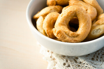 Artisanal homemade typical apulian taralli, used as a baked snack in south italian culture.