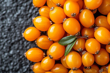 Vibrant Close-Up of Fresh Orange Berries on Textured Background with Green Leaf