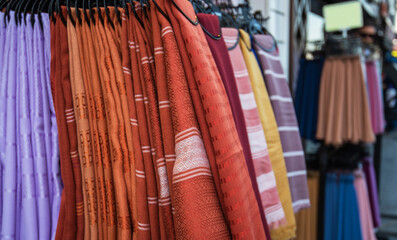 Egyptian bazaar. Istanbul. Turkey. Display with draperies and scarves. Variety of purchases of a traditional original scarf. Selective focus.