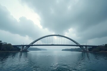 Naklejka premium Bridge with a distinctive curved shape under a grey cloudy sky, cloud, shape