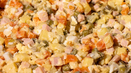 A colorful salad with a variety of vegetables and ham