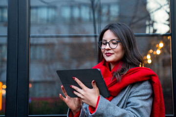 Young businesswoman working with tablet in front of a business center
