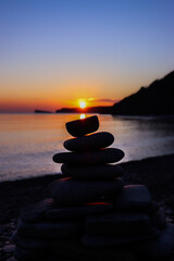 Pyramids of stones against the sunset. Harmony.