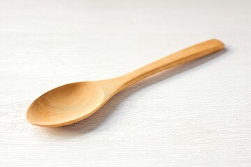 Wooden spoon on white background