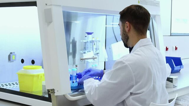 Scientist handling test tubes in a sterile laboratory environment