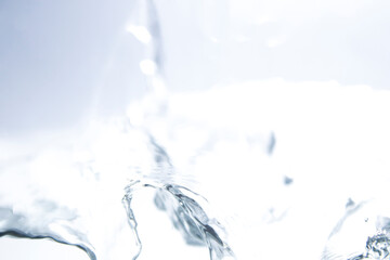 Beautiful Water Splash with Light Reflection on Bright Background