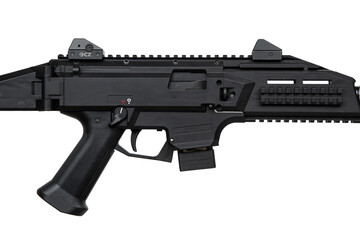 A modern black PCC (Pistol Caliber Carbine) with a suppressor, tactical rails, and adjustable...