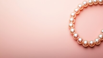Obraz premium Pearl necklace arranged in a circle, soft pink backdrop