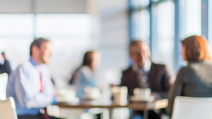 A blurred image of a casual business meetup in a coffee shop or informal environment.
