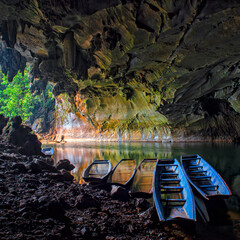 Kong Lor Cave in Phu Hin Bun National Park, Laos- Khammouane Province, Laos. Boat rafting in...