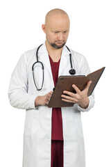 Thoughtful male doctor in a white coat reviewing data on a tablet in a leather case