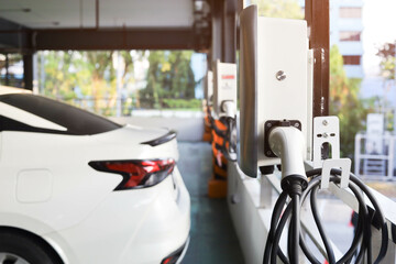 Modern electric vehicle charging station in an outdoor parking lot in the city