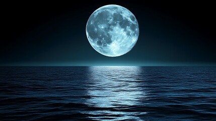 Full blue moon over calm ocean at night.