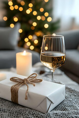 Cozy Christmas Eve White wine glass, gift, candlelight, blurred Christmas tree. Perfect for holiday greeting cards or festive blogs