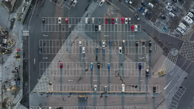 Aerial View Down of Large Car Park with a Car Parking in a Space