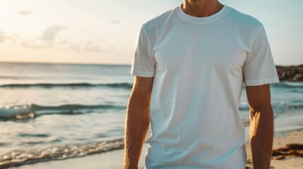 Man in white t-shirt on the beach overlooking the sea. Ideal for travel sites, advertising beachwear and summer collections.