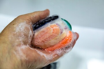 Fototapeta premium Used soaps glued together to form a ball. Ball of Used Soaps of different colors. economy and use