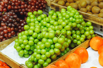 A fresh bunch of shiny muscat grapes at the market. Shine Muscat