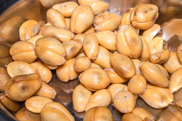 Salacca or Salaka, a tropical fruit, peeled and placed in a stainless steel container. This fruit has a sweet and sour taste.