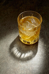 Whiskey with ice in a crystal glass.