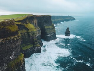 aerial view of the cliffs of moher, ireland, with crashing waves.