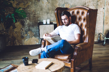 Focused young man relaxing in loft room