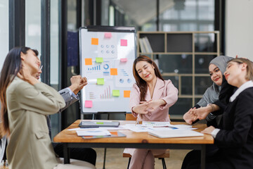 Business Asian people, laptop and conversation with research, teamwork and connection in the office. Group, employees and accounting with computer, internet and cooperation with meeting and planning