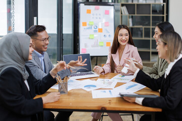Business Asian people, laptop and conversation with research, teamwork and connection in the office. Group, employees and accounting with computer, internet and cooperation with meeting and planning