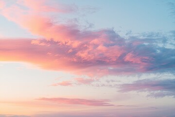 Fototapeta premium Serene Sunrise Sky Soft Clouds Tinged with Radiant Hues of Pink, Orange, and Blue