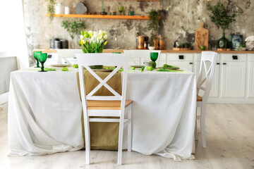 Interior design scandinavian kitchen with table and chair. Cozy Wooden white cuisine decorated with flowers and decor. Kitchen utensils, dishes, plates on shelves. Stylish dining room with furniture	
