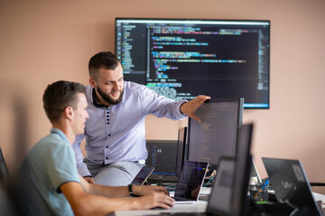 Programmers engrossed in deep collaboration, diligently working together to solve complex problems 